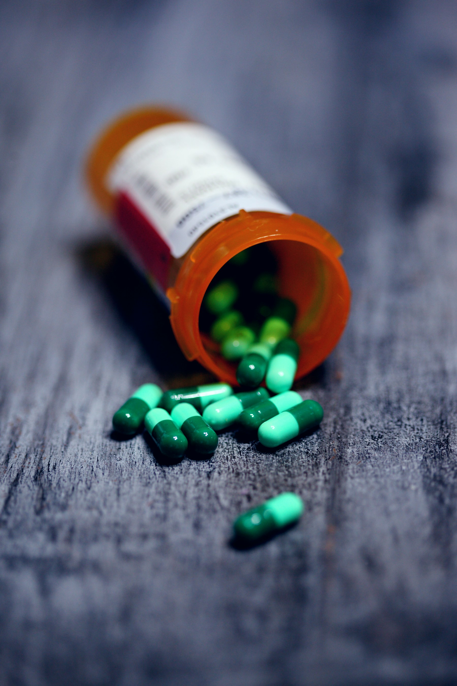 A close-up of prescription pill bottles on a pharmacy counter